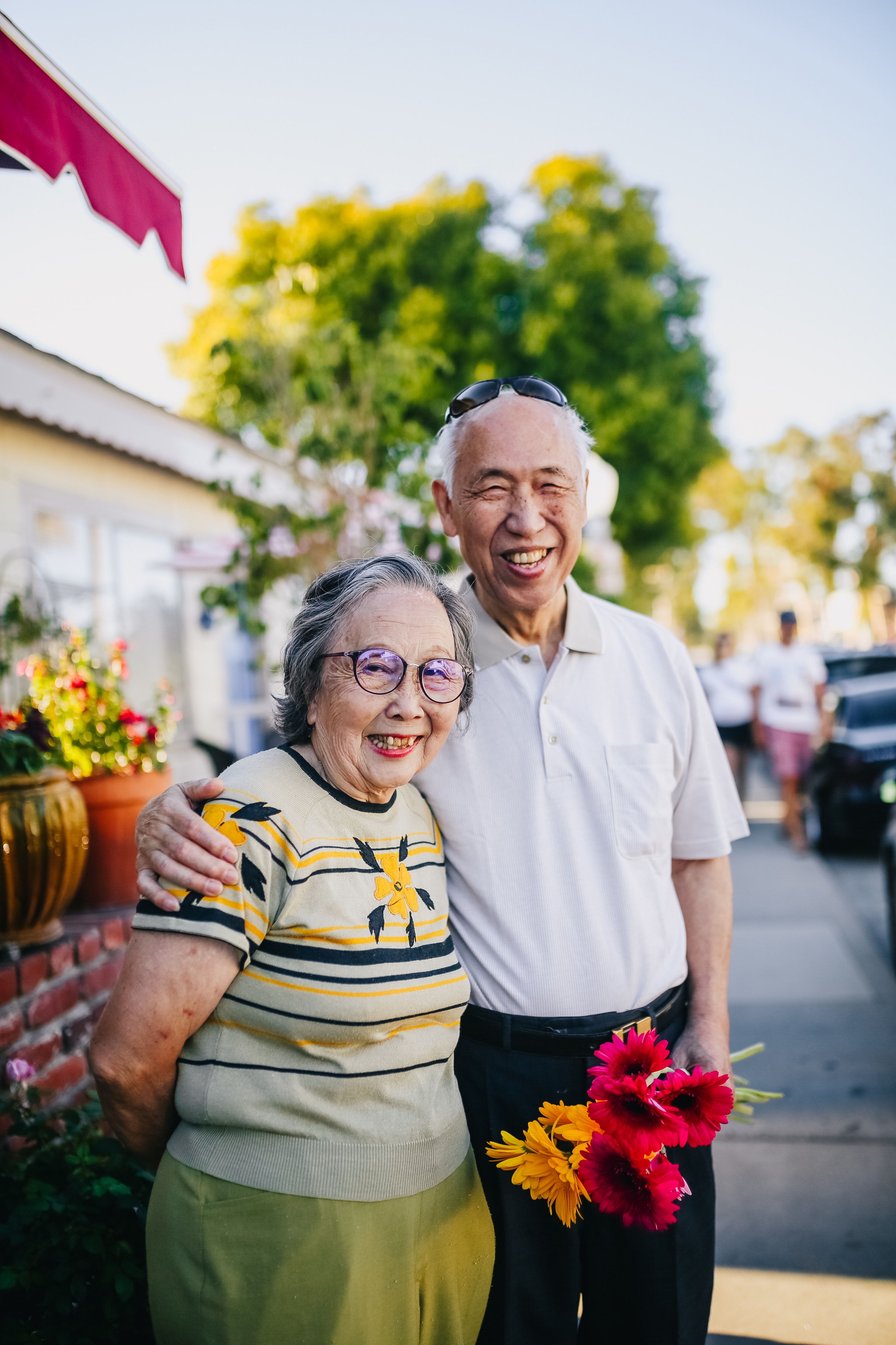 man and woman holding flowers